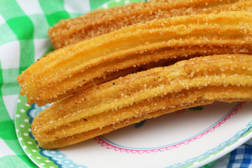 Spanish churros on plate, closeup
