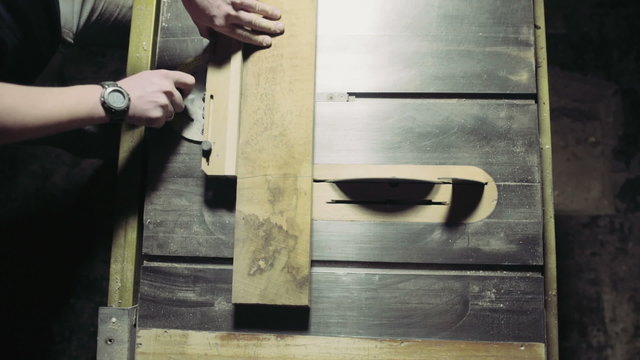joiner cut a wooden plank with circular Saw slow motion