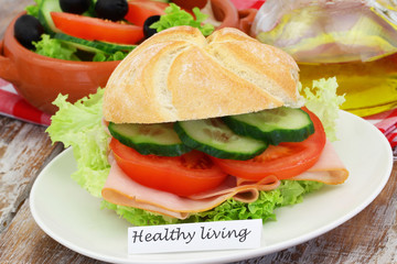 Healthy living card with bread roll with ham, lettuce, tomatoes and cucumber
