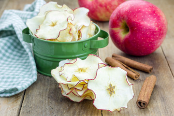 Healthy snack. Homemade apple chips on rustic wooden background