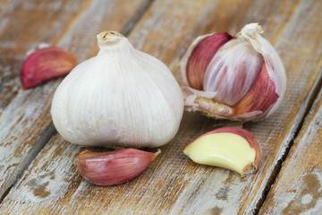 Garlic cloves on rustic wooden surface
