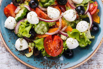 Greek salad , mini mozzarella in a bowl shape.selective focus
