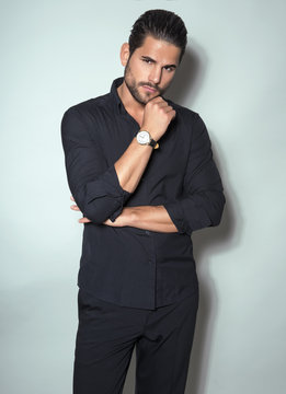 handsome young man in black dress shirt wearing a wristwatch
