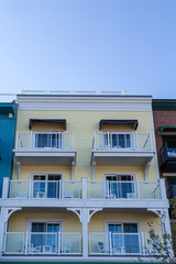 Six White Balconies on Yellow Wood Building