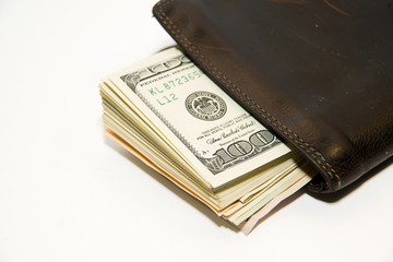 Old wallet with banknotes of US dollars inside