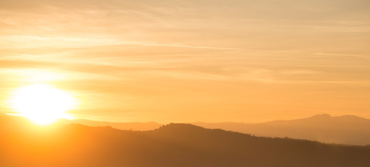 Orange sunset behind mountain range