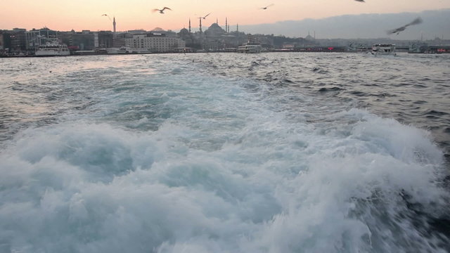 Voyage at the back of a passenger boat, departure from Eminonu port at sunset in Istanbul Turkey. Progressive scan at 50p slowed down to 25fps to make a half speed slow motion. Nikon D5300.