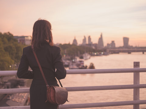 Young woman admiring London at sunrise