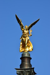 Fototapeta premium MUNICH, GERMANY - Gilded statue featuring a Peace Angel (Friedensengel) on the top of a column