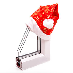 Plastic window profile with a cap of Santa Claus on a white background