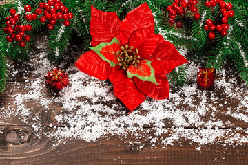 Beautiful Christmas background with the branches of the Christmas tree and snow on wooden background. View with copy space