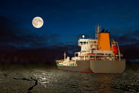 Frozen sea and tanker ship at night.
