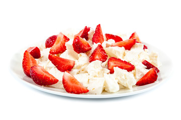 Fresh sliced strawberries in a cottage cheese in a bowl