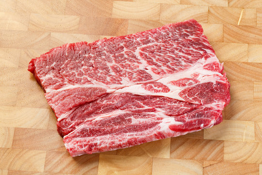 Beef chuck steak on chopping board