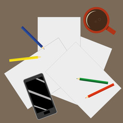 View from above of a desktop with blank sheets of paper, pencils a mobile phone and a cup of coffee as preparation for paperwork or sketching