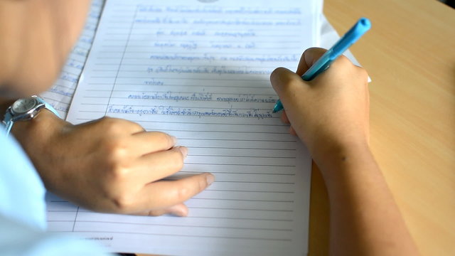 close up a hands of student during the exam in the classroom