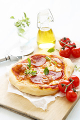 Pizza with salami and oregano