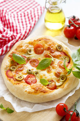 Pizza with tomatoes, cheese and basil