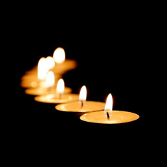 Burning candles on a black background