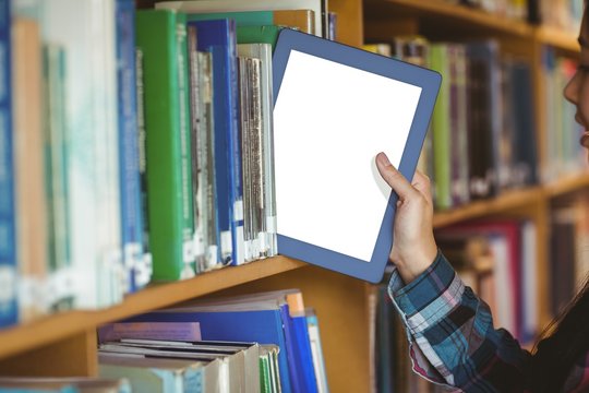 Pretty Student Putting Table In Bookshelf