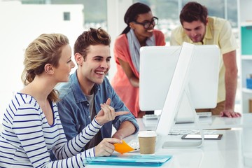 Creative business team working hard together on pc