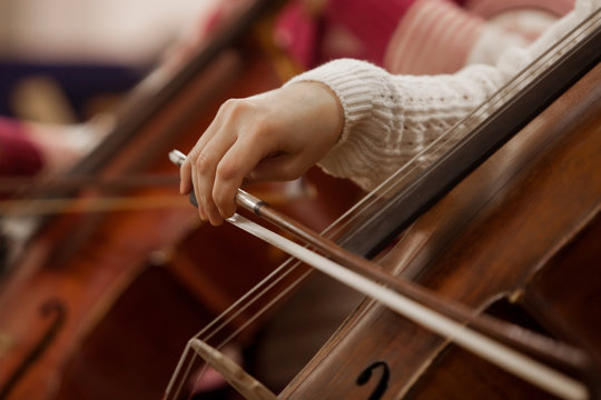  Hand girl playing cello closeup