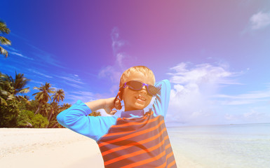 happy boy in swimming goggles on beach