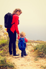 mother and little daughter travel in mountains