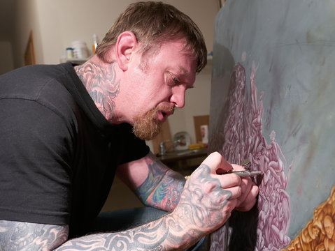 Portrait of painter airbrusher in art studio