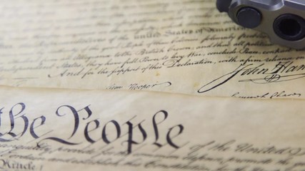 US Constitution Bill of Rights with hand gun - History of the Second Amendment - Powered by Adobe