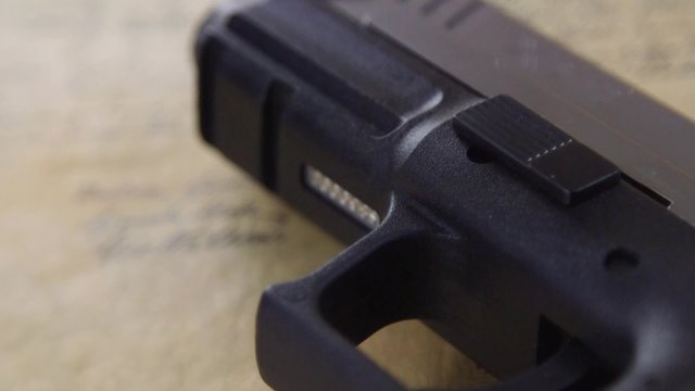 US Constitution Bill of Rights with hand gun - History of the Second Amendment