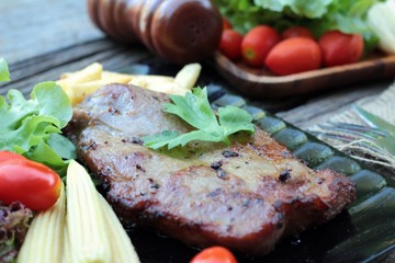 Pork steak of delicious with vegetable and tomato.
