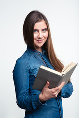Happy woman holding book and looking at camera