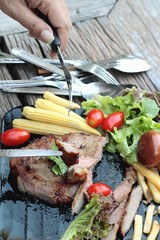 Pork steak of delicious with vegetable and tomato.