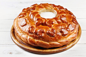 Russian wedding round loaf close-up on wooden table. Wedding bread with salt. Russian wedding ceremony 