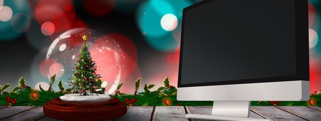 Composite image of christmas tree in snow globe