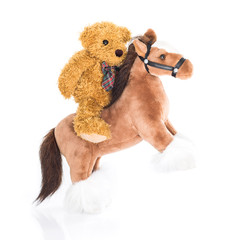 Teddy bear riding a horse