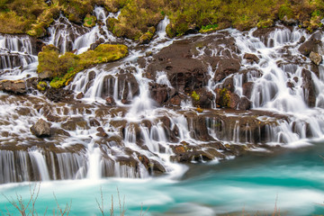 The amazing Hraunfossar waterfall with its deep blue water in Iceland