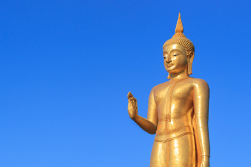 Gold Buddha Statue on blue sky