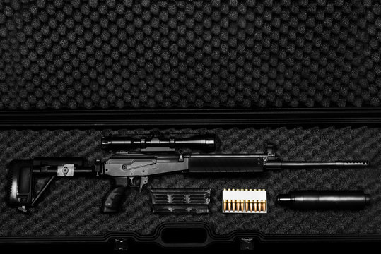 sniper rifle in a case on the dark background
