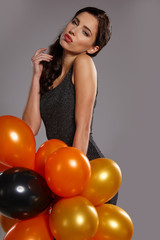 Fototapeta na wymiar smiling woman holding ballons and celebrating
