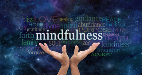 Zen Mindfulness Meditation  - Female hands reaching up towards  the word 'Mindfulness' floating...