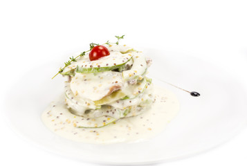 Herring salad with avocado sauce on a plate in a restaurant
