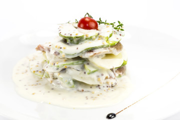 Herring salad with avocado sauce on a plate in a restaurant