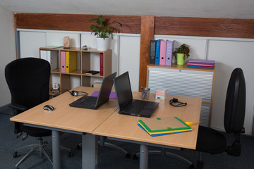 Office desk with two laptops, job or business concept