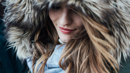 Young woman with fur hood