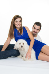 Happy Young couple with a white dog - first baby