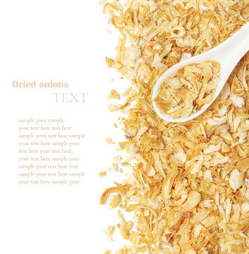 Dried chopped onion in a white ceramic spoon