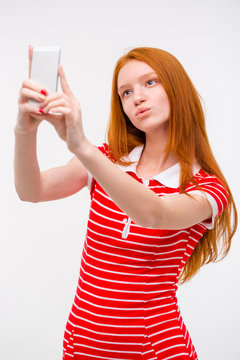 Young beautiful redhead woman  taking selfie and making duck face