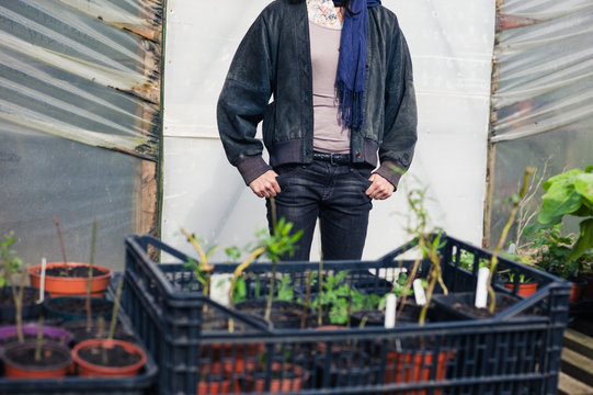 Woman standing outside greenhouse